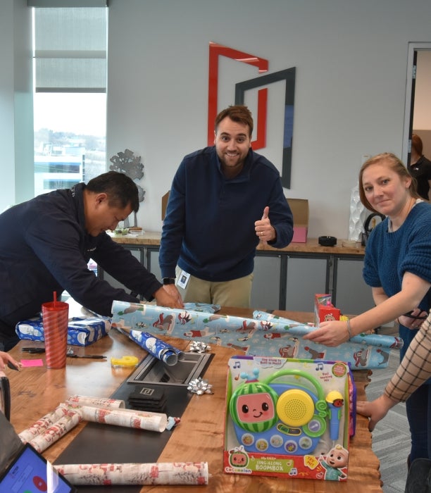 MITER Brands Team wrapping gifts.
