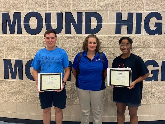 Two MITER Foundation scholarship recipients from Flower Mound High School in Texas display their certificates.