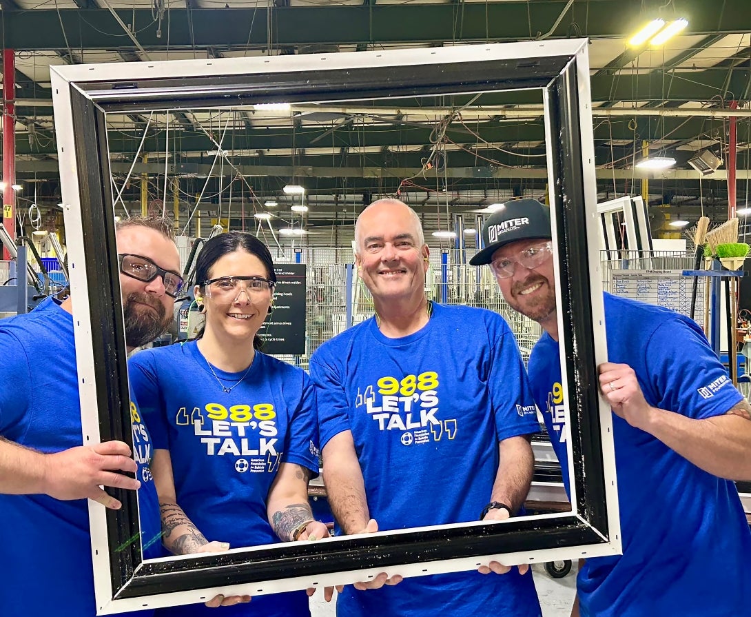 From left to right: MITER Brands team members Josh Lewis, Amelia Libby, David Bandy, and Nick Plancich wearing 988 t-shirts to spread awareness of AFSP’s Suicide and Crisis Lifeline