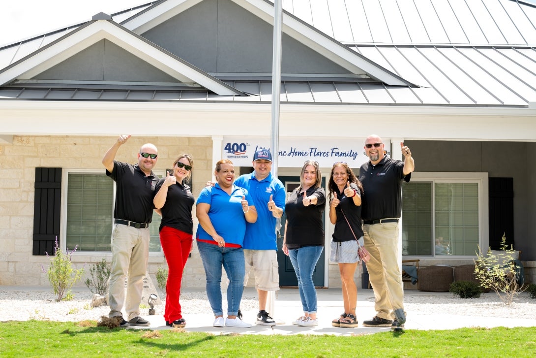 From left to right: MITER Brands team member David Villasenor and his wife, Ana; home recipient Marine Lance Corporal Alberto Flores Jr. and his wife, Elvira; MITER Brands team member Kristina Rosso; and MITER Brands team member JR Minnich and his wife, Michelle; celebrating the 400th specially adapted custom home built by Homes For Our Troops