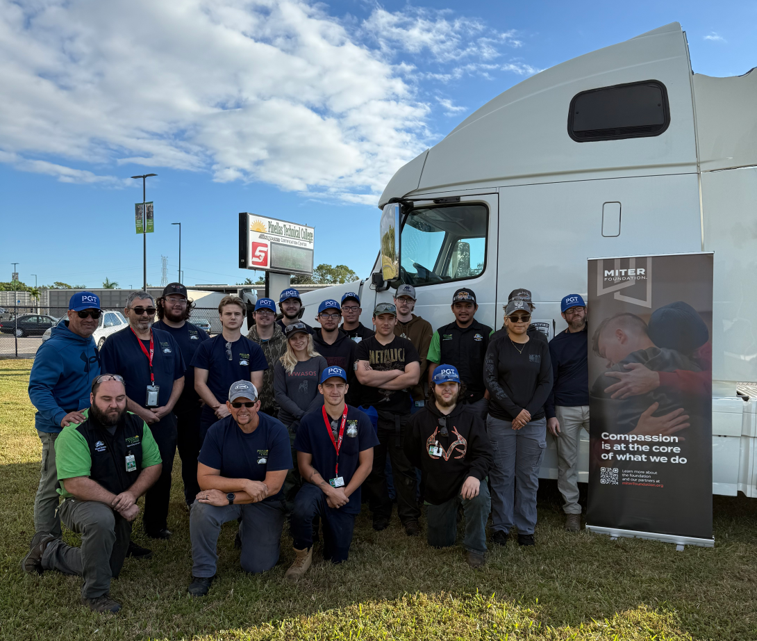 Pinellas Technical College instructors and students pose with a decommissioned truck donated to the program by the MITER Foundation.