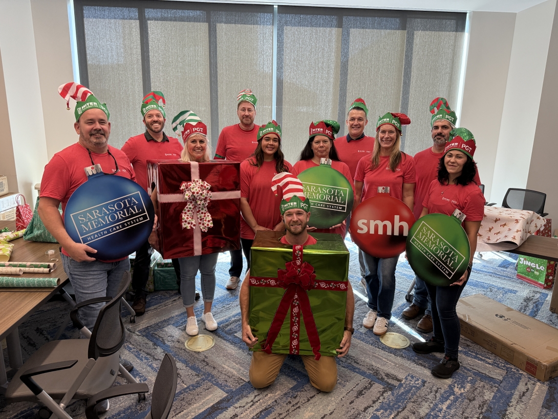 MITER Brands team members (left to right) Troy Guinn, Kristofer Spencer, Julie Guinn, Karl Rekus, Emily Beam, Noah Copenhaver, Jean Korovich-Beam, Ronnie Sopcich, Katie Fegan, Jeff Brown, Sarah Graf, volunteered to wrap gifts and decorate the room for the annual Women and Children Holiday Event at SMH-Venice Campus.
